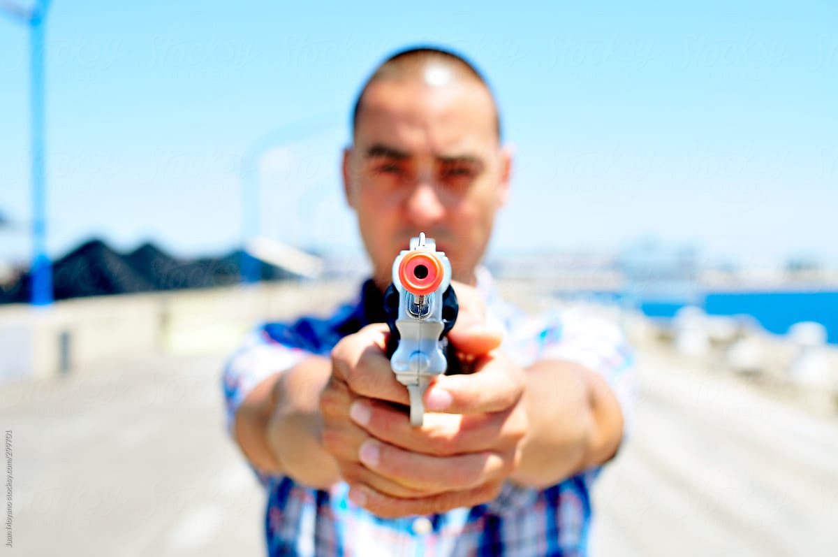 young man with a toy gun