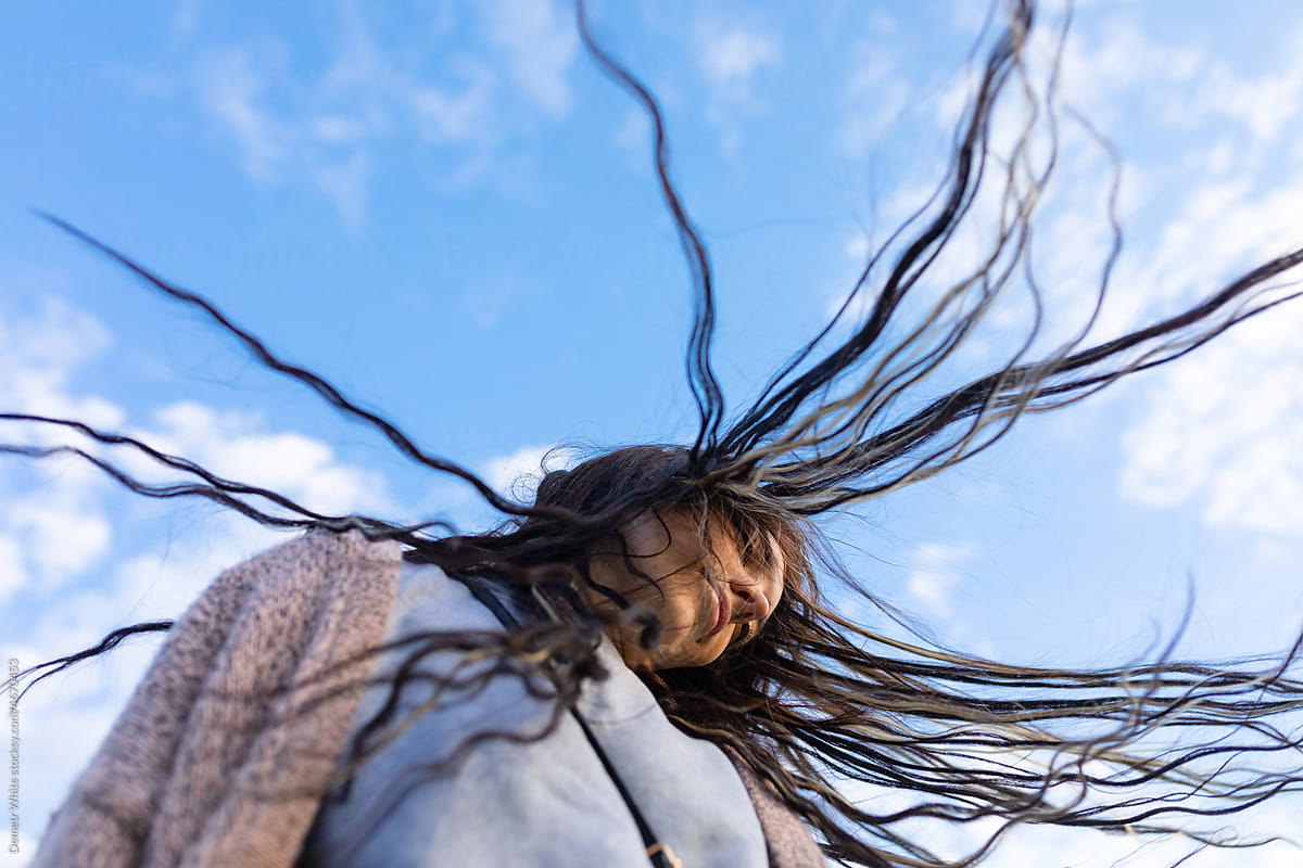 woman\'s hair flutters beautifully in the wind
