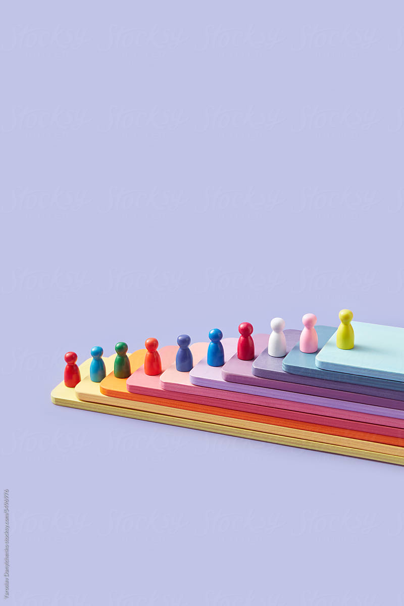 Game pawns of various colors on multicolored wooden panels.