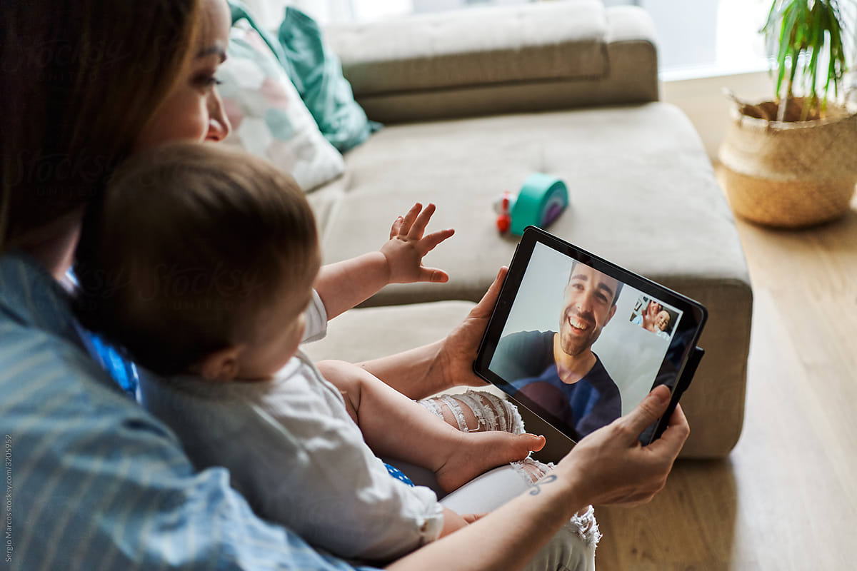 Mother with baby making video call to father