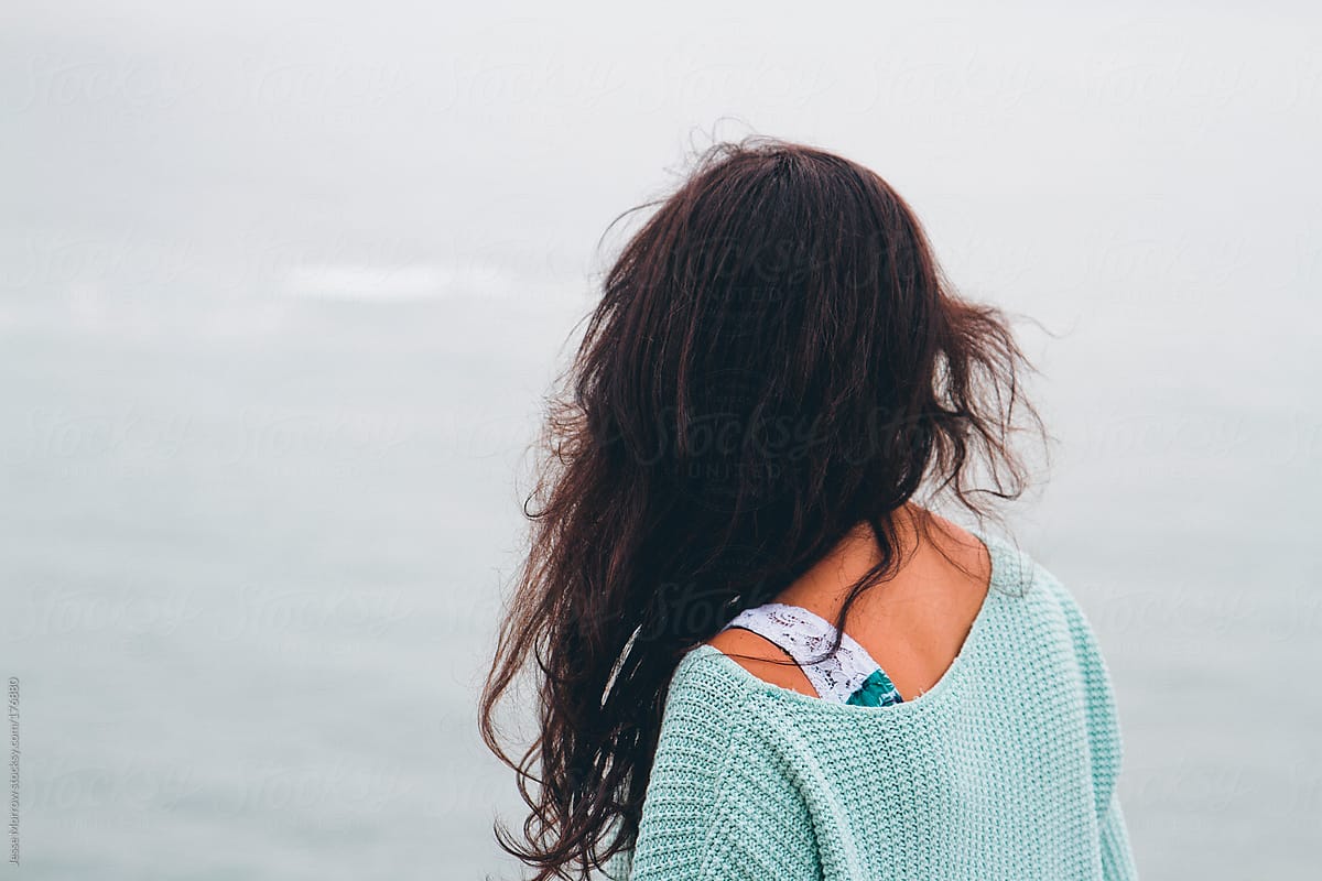 young woman looks out at the ocean