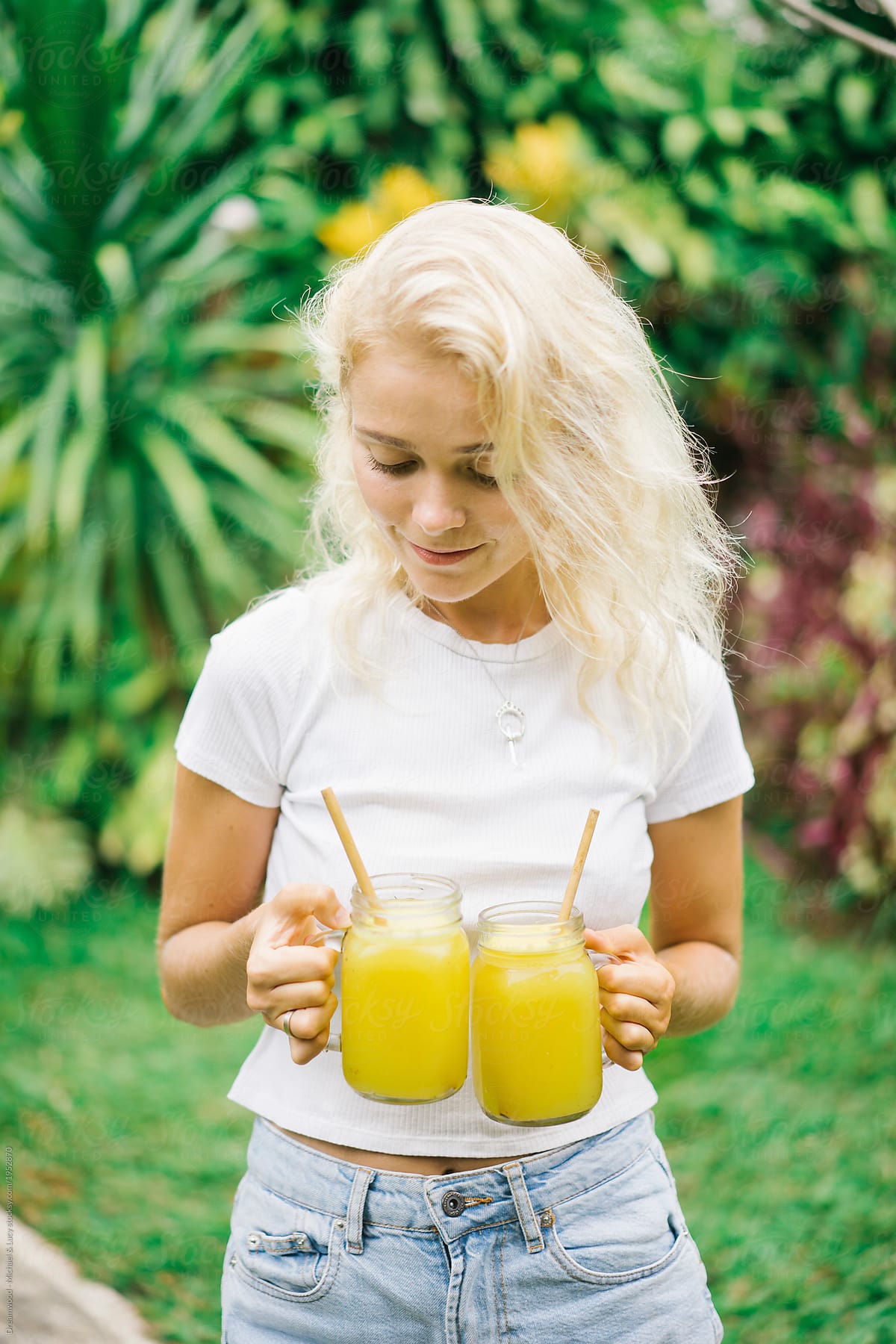 Content girl holding healthy drinks