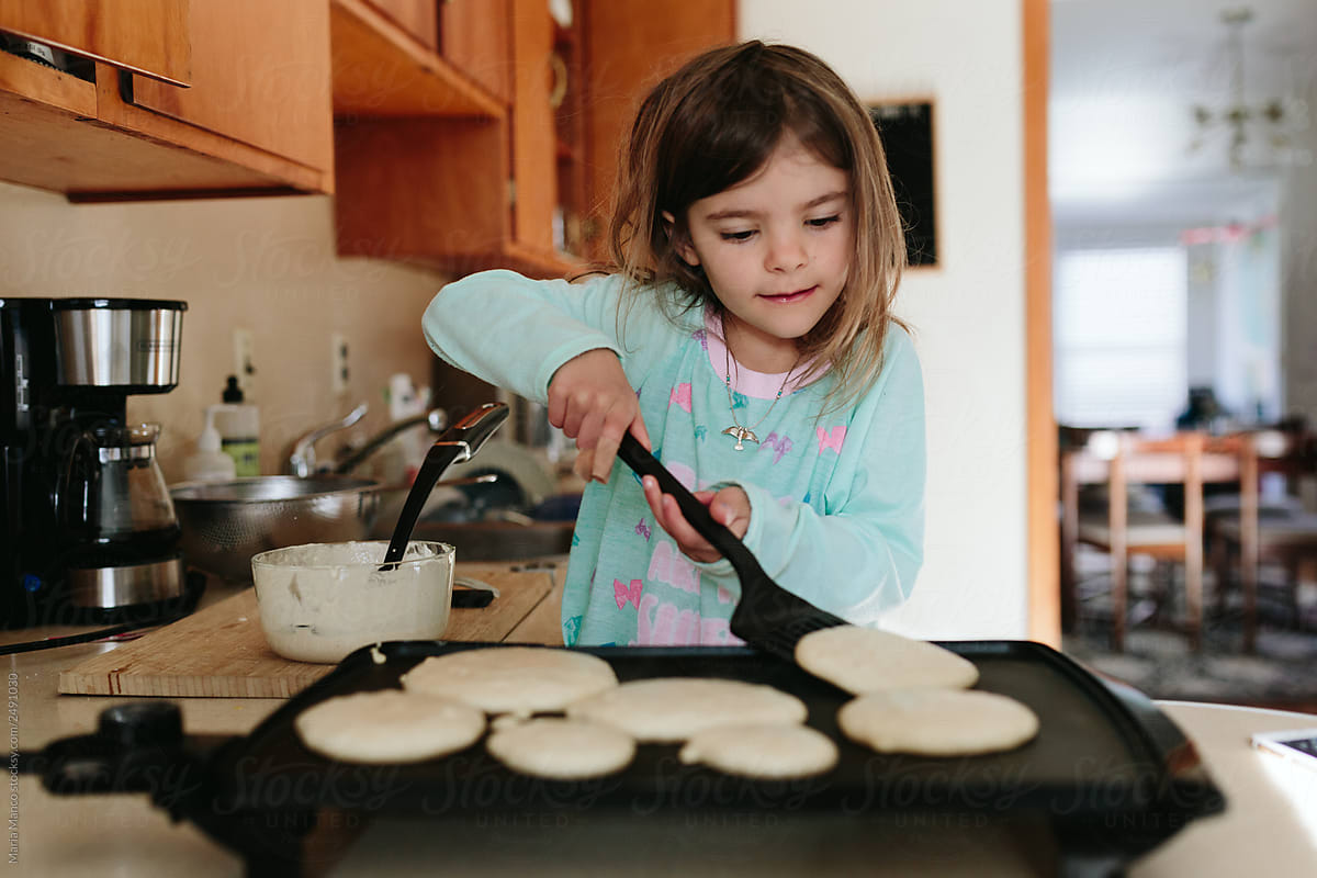 child makes pancakes