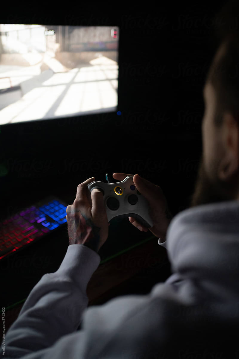 Man with controller playing in computer games