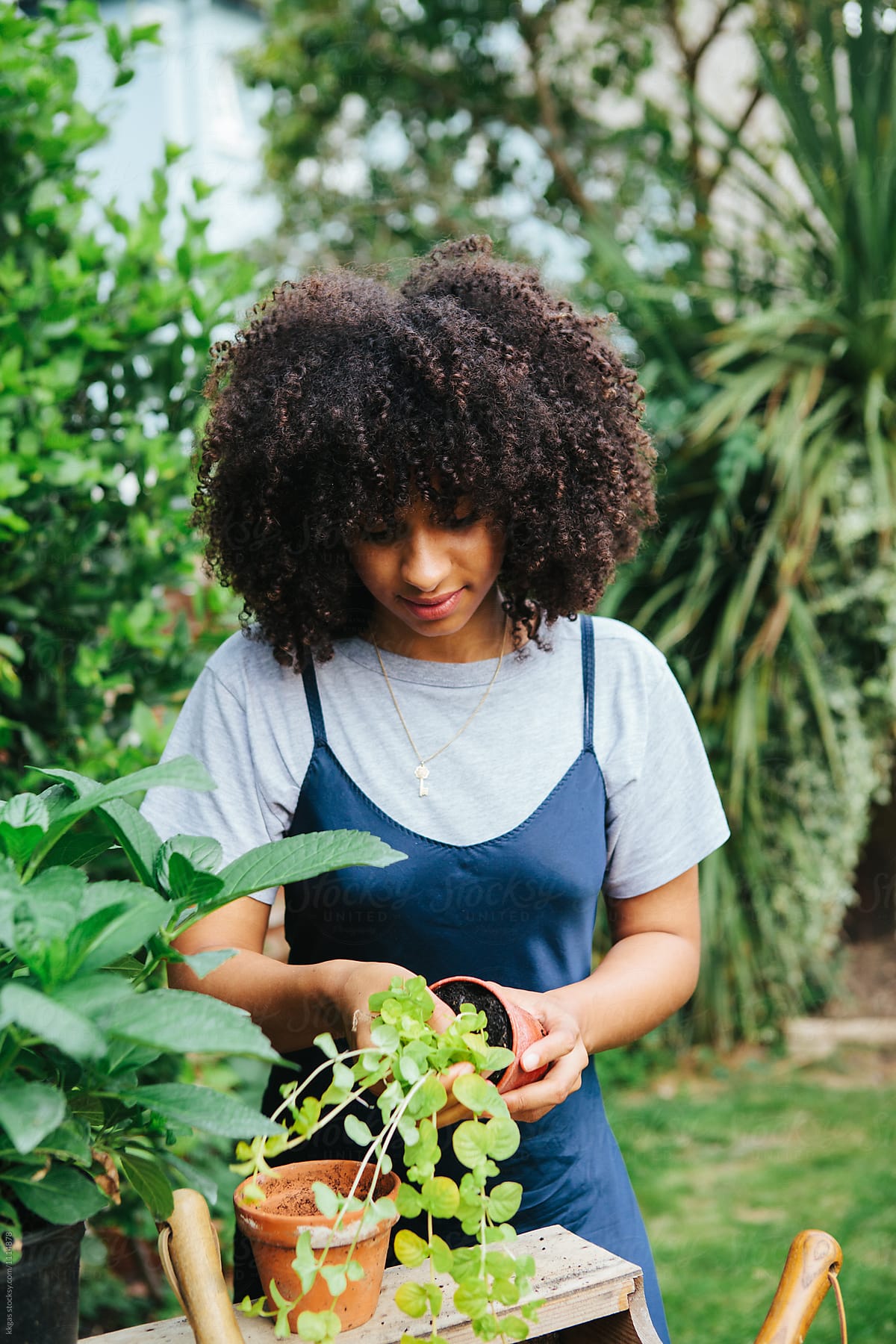 Mixed race woman gardening