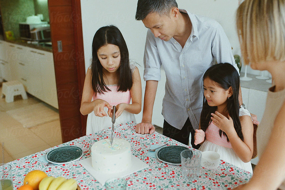 Family cutting a  birthday cake