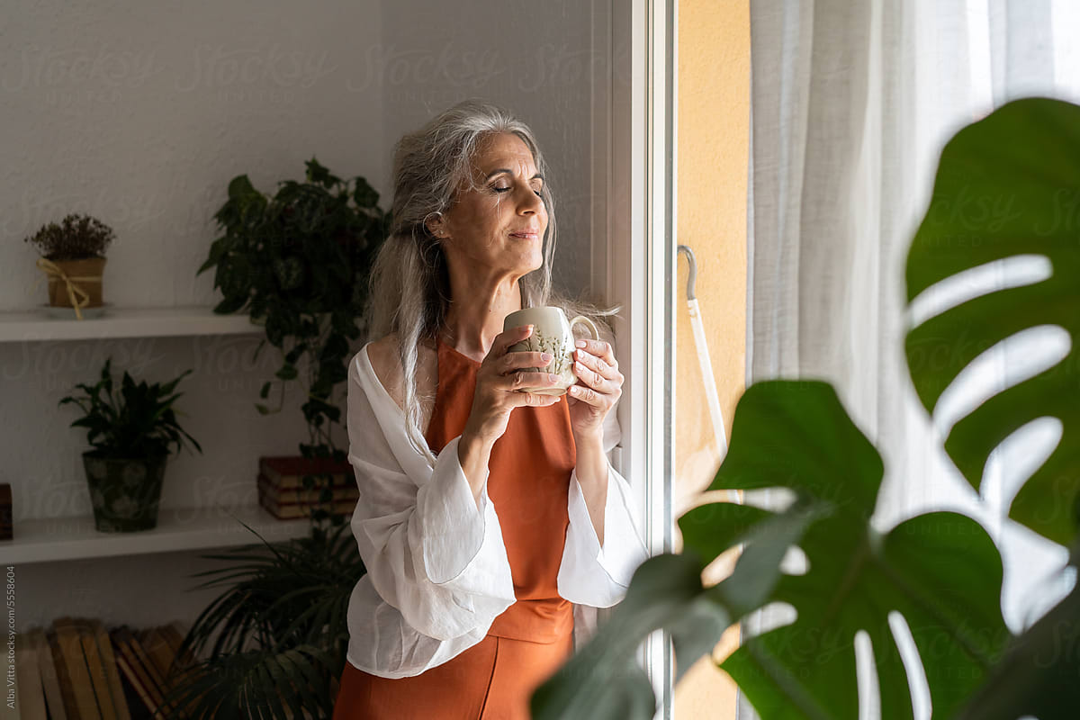 Happy retired woman with coffee cup portrait