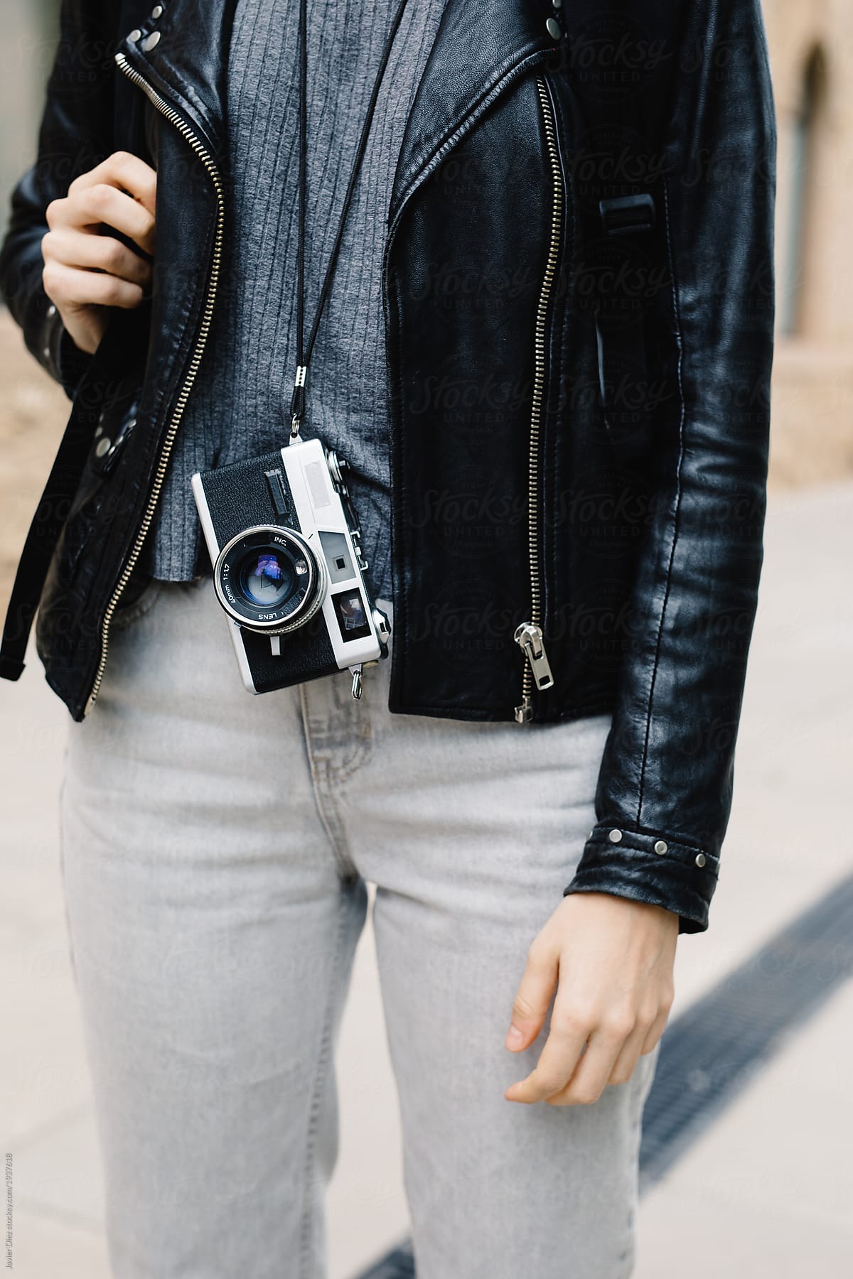Crop trendy woman with backpack and camera