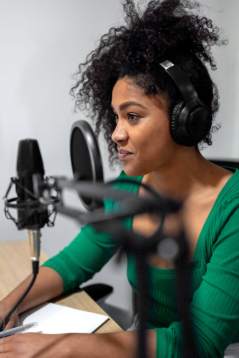 Stylish black woman working in radio studio
