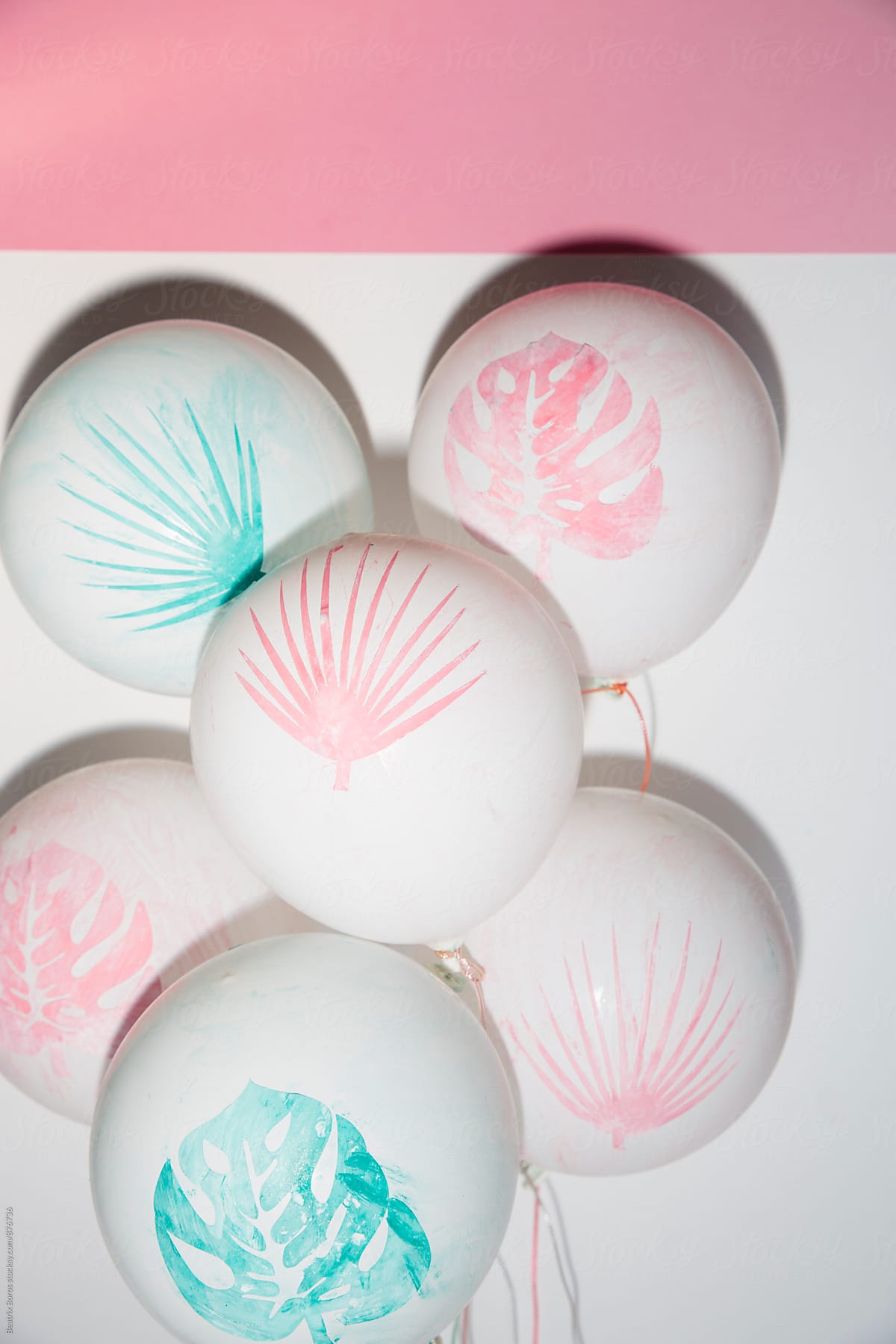 Festive hand painted summer balloons on white and pink background