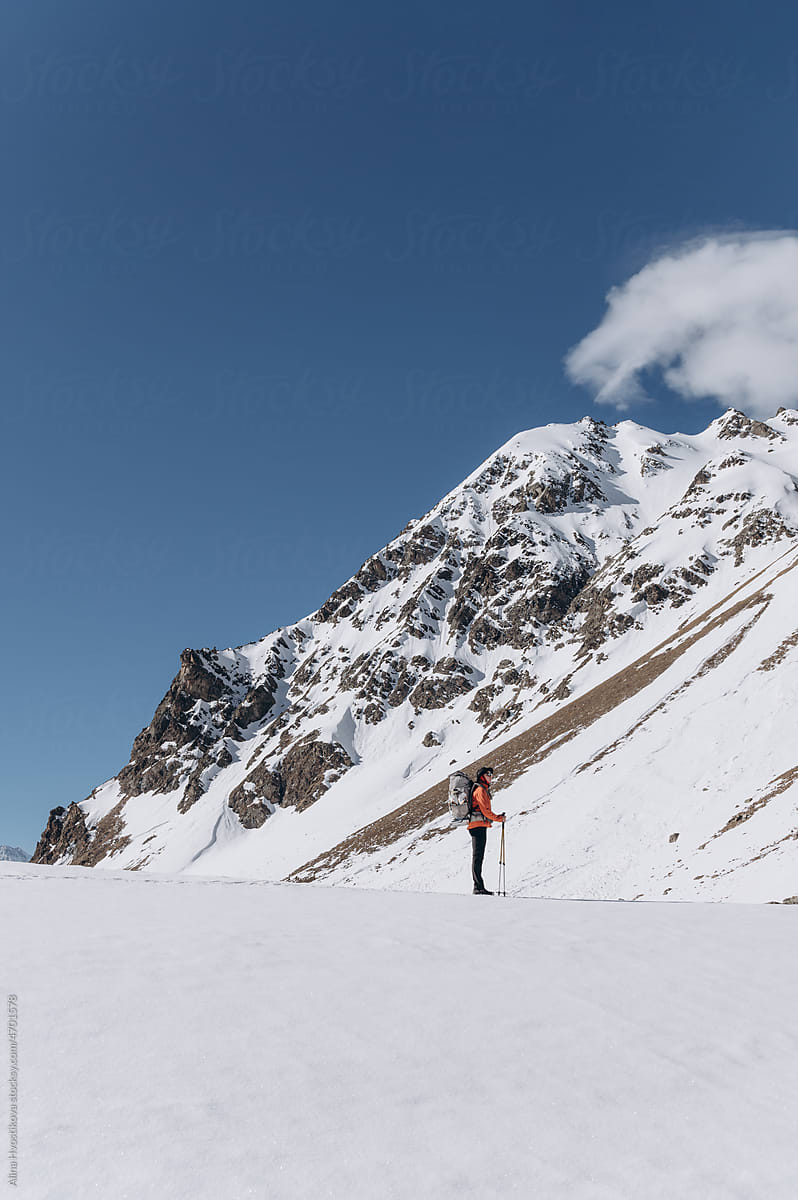 Anonymous hiker near snowy mountain in winter