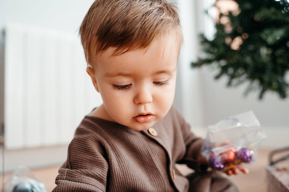 Boy holding Christmas ornaments