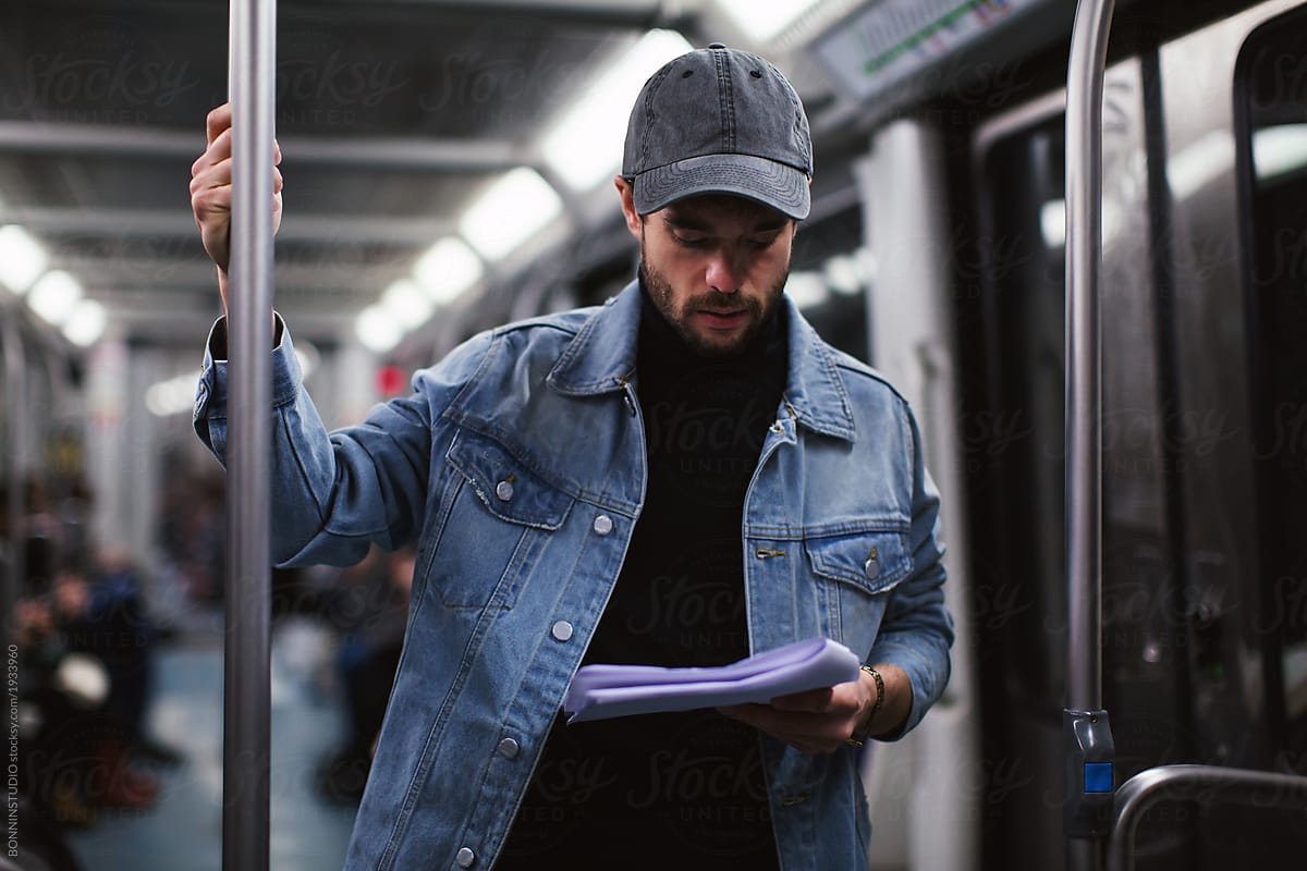 Actor reading script in subway.