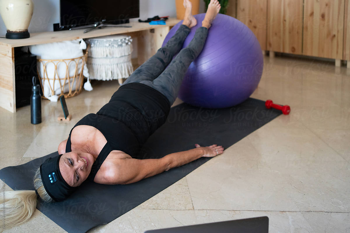 Energectic woman doing pilates at home