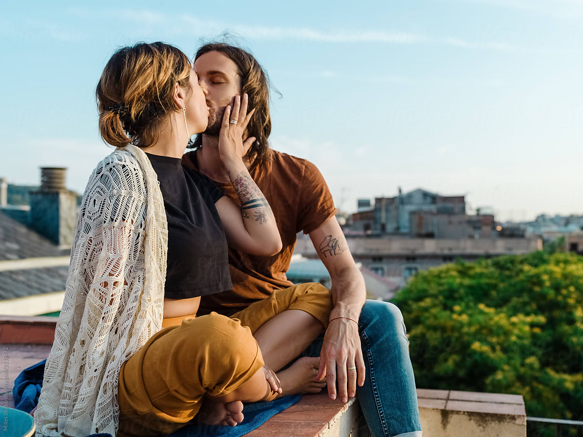 Kissing happy couple on rooftop
