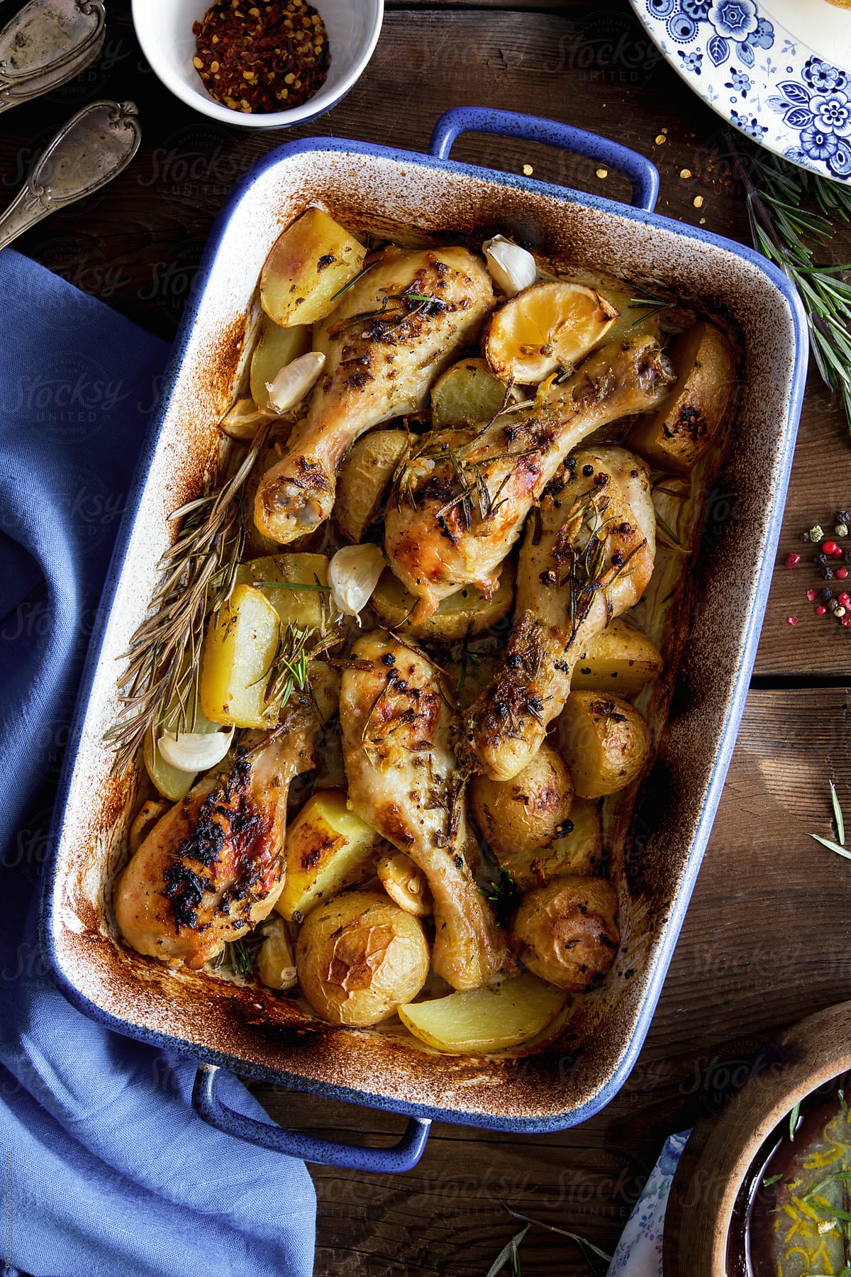Food: roasted chicken legs on bed of potatoes and herbs