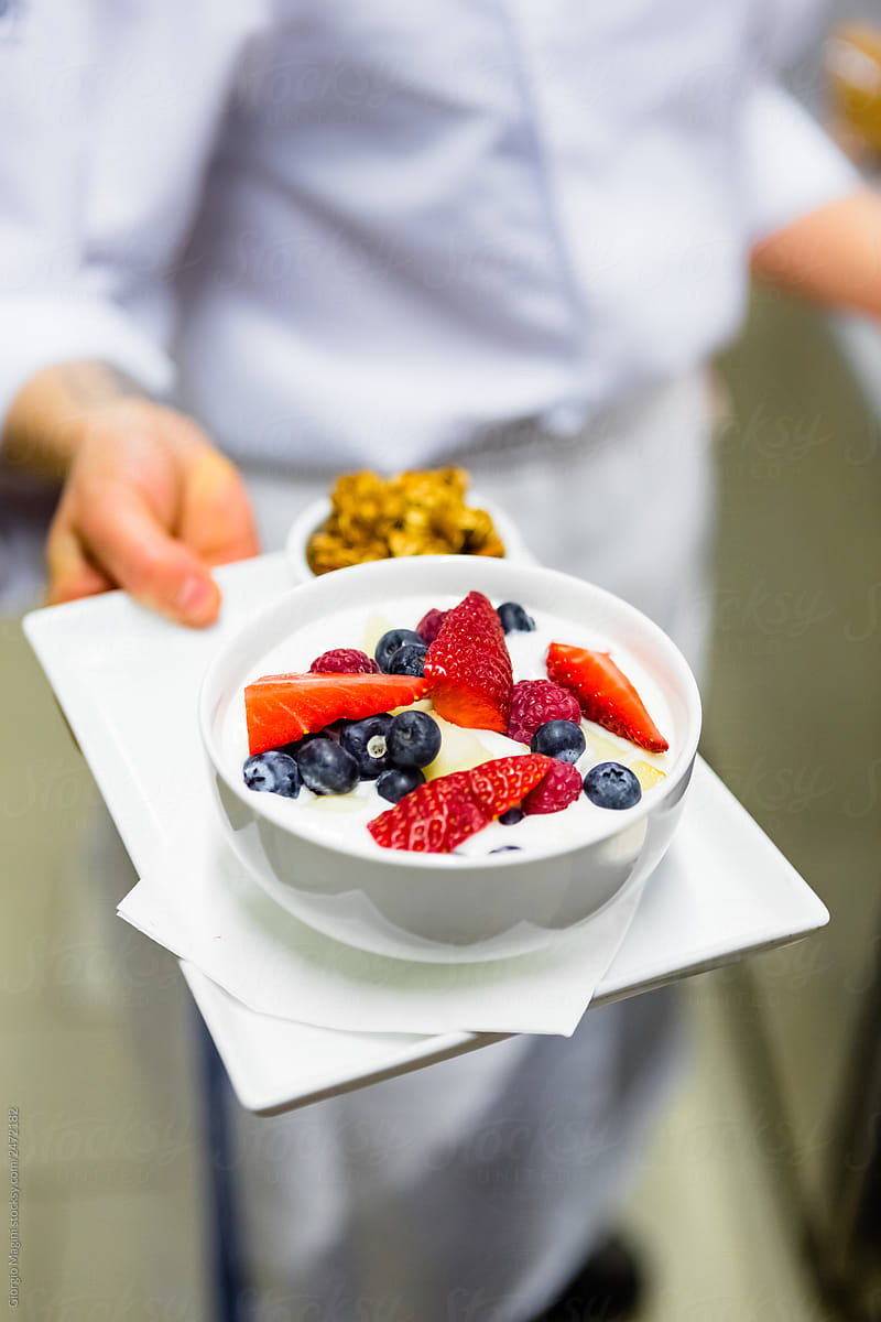 Chef Offering Healthy Breakfast with Yogurt and Berries