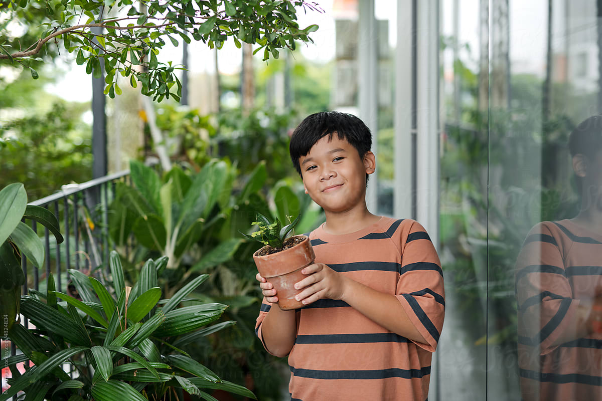 Cute Asian boy with ornamental plants.
