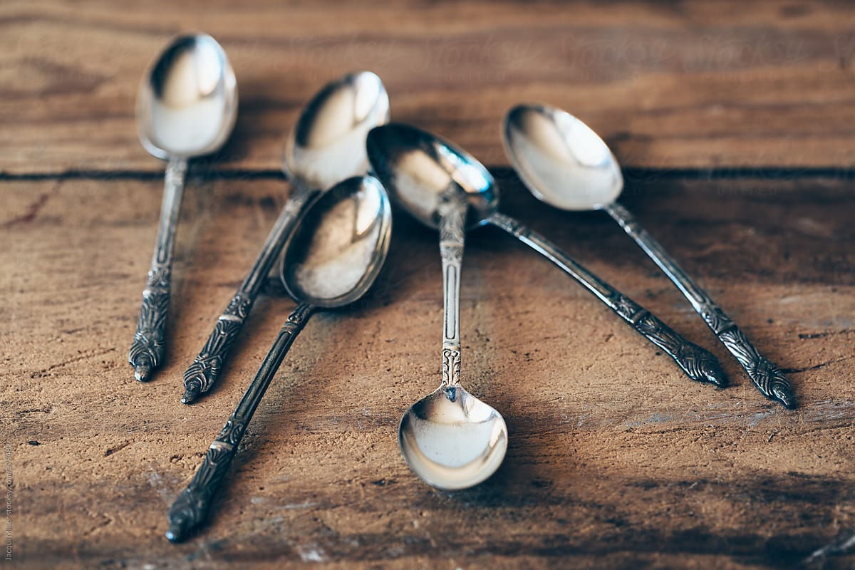 Six antique Apostle teaspoons on a rustic wooden table