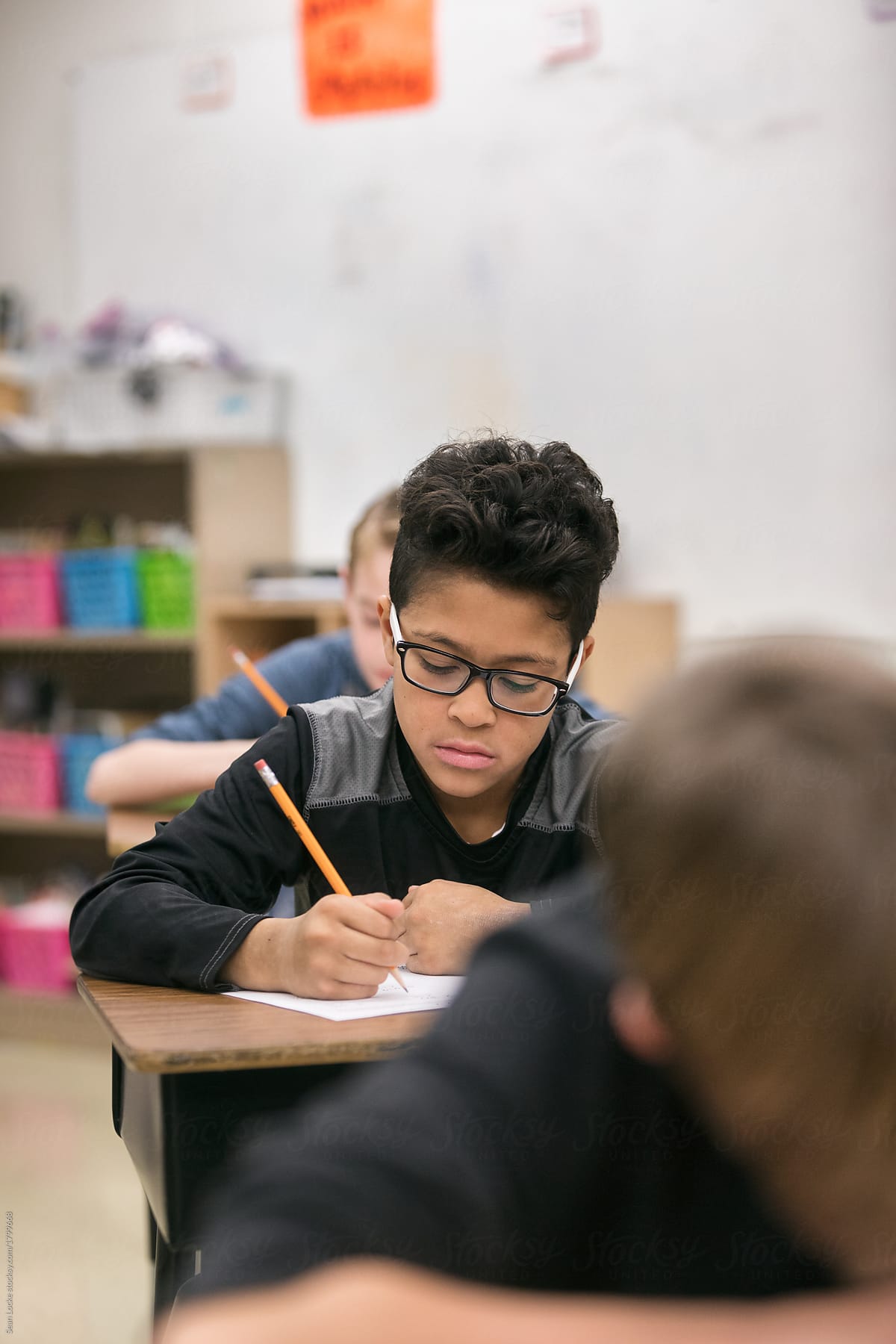 Classroom: Boy With Glasses Doing Classwork