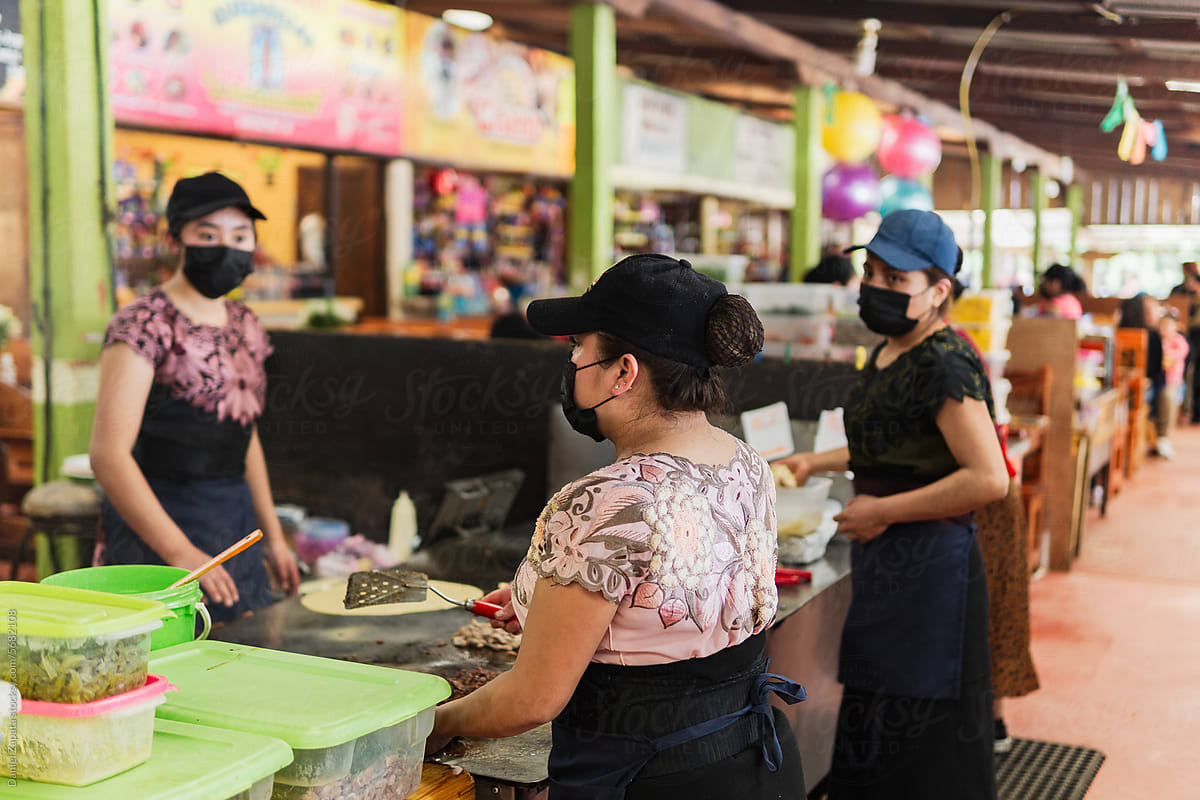 Three women working in a local market in Mexico.
