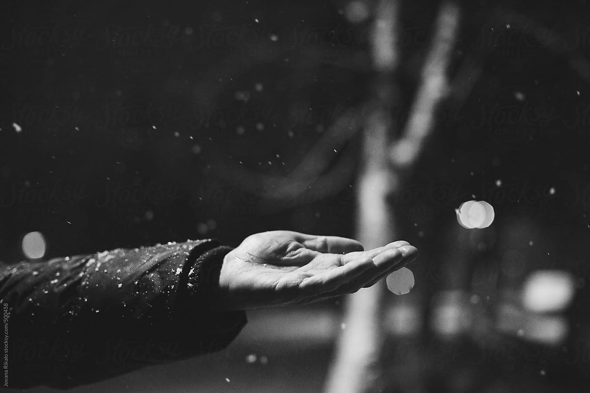 Snowflakes falling into an open hand during a snow storm