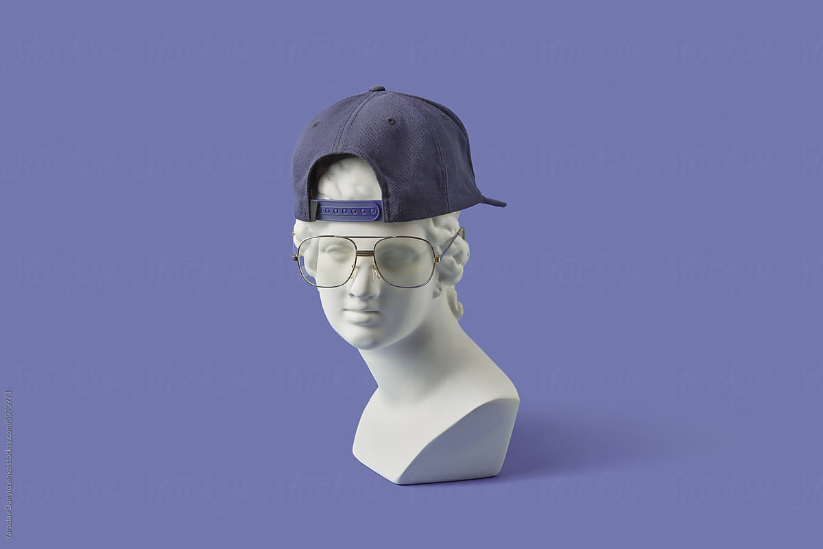 Plaster statue in glasses and cap backwards.