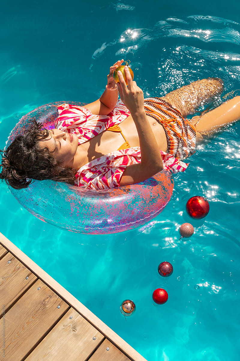 Woman with bauble in swimming pool