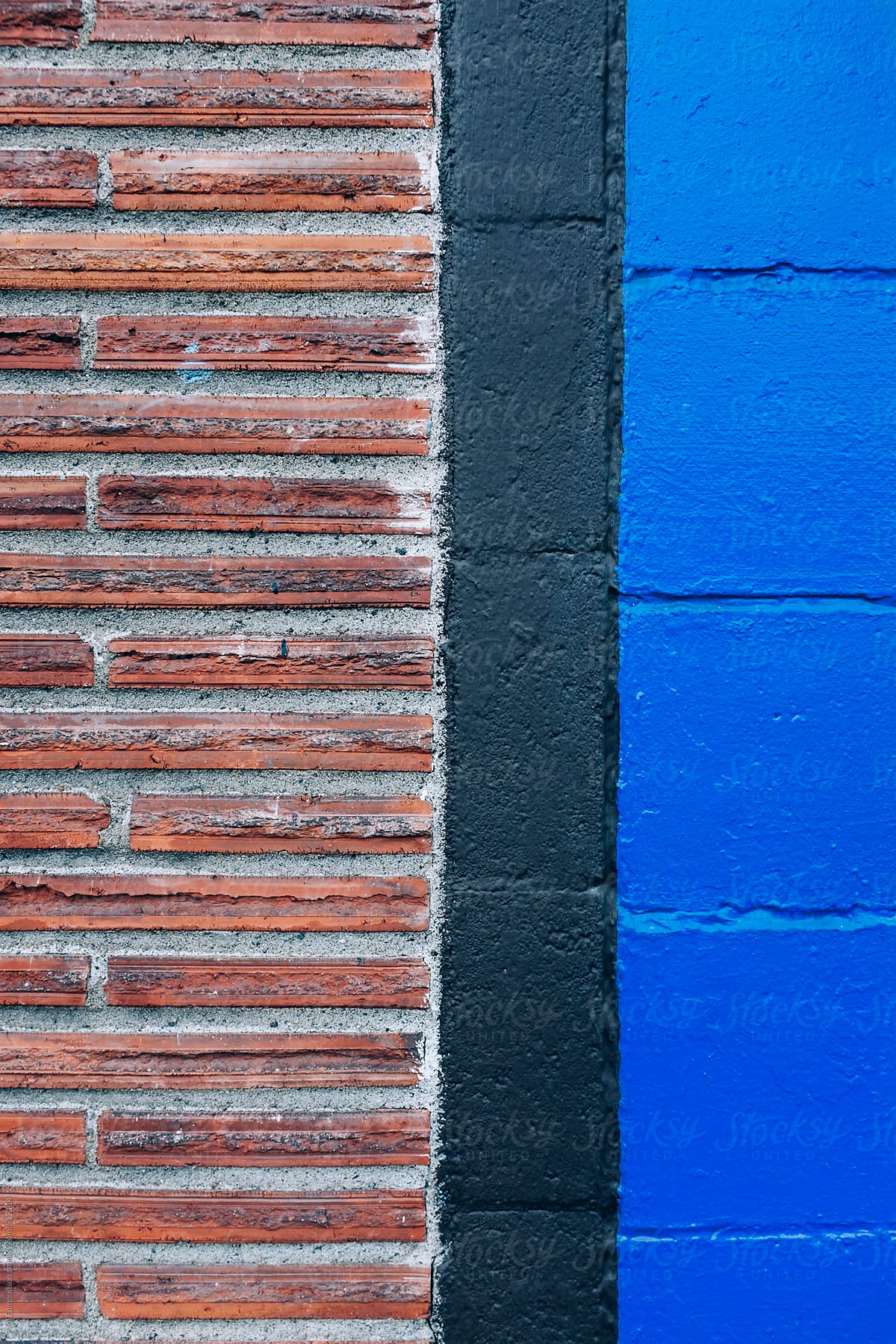 Detail of brick and painted cinderblock wall