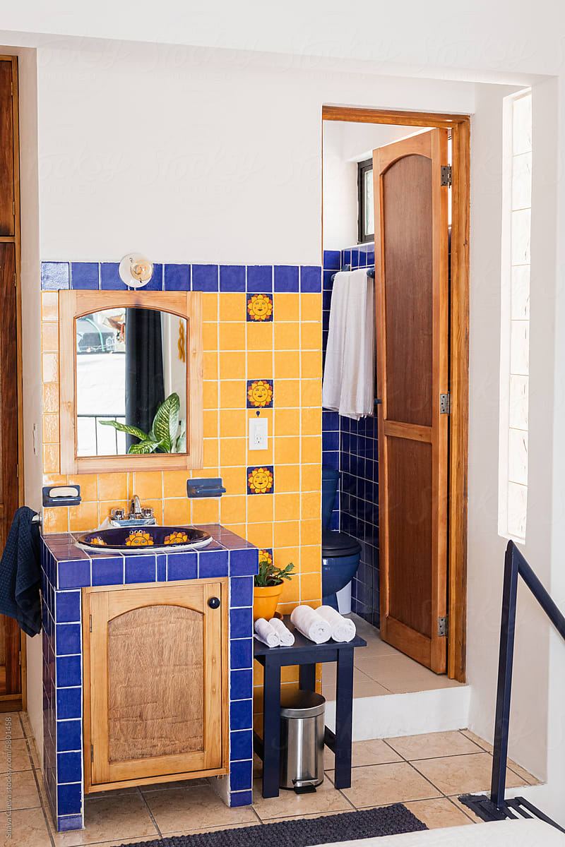 A blue and yellow tiles washbasin