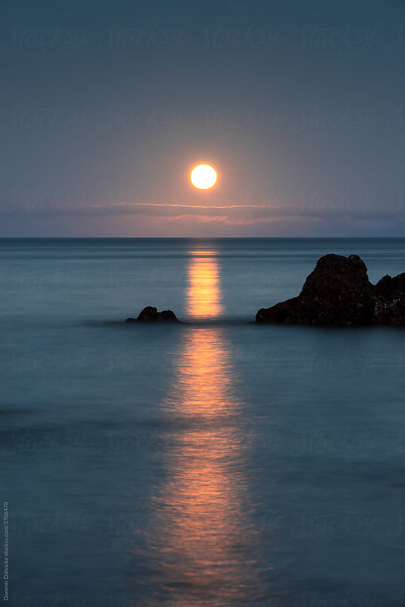 Long exposure on the coast with a full moon.