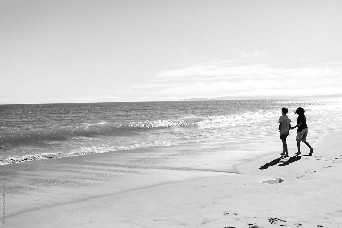 Children walking by the beach