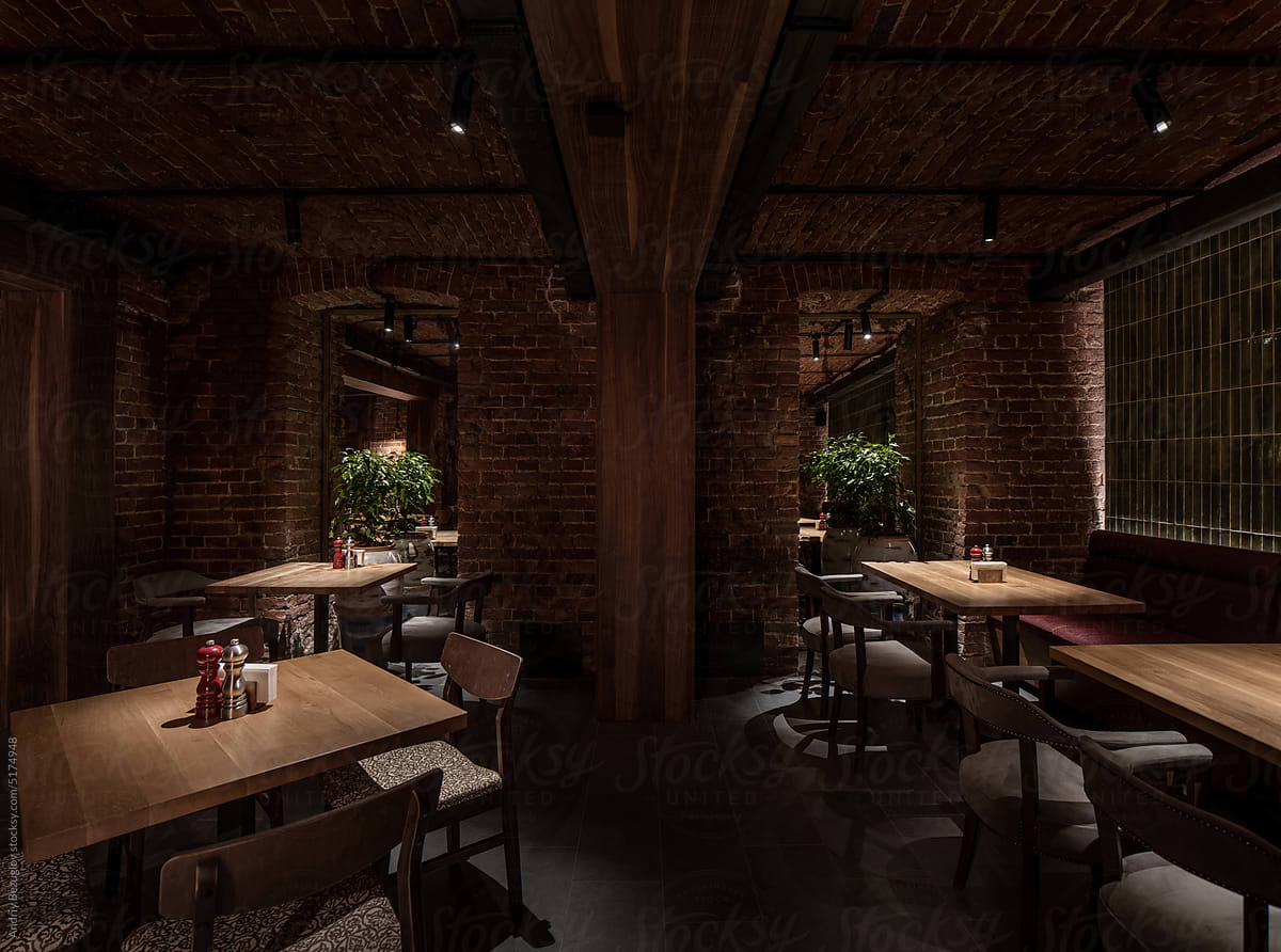 Illuminated restaurant in loft style with shabby brick walls
