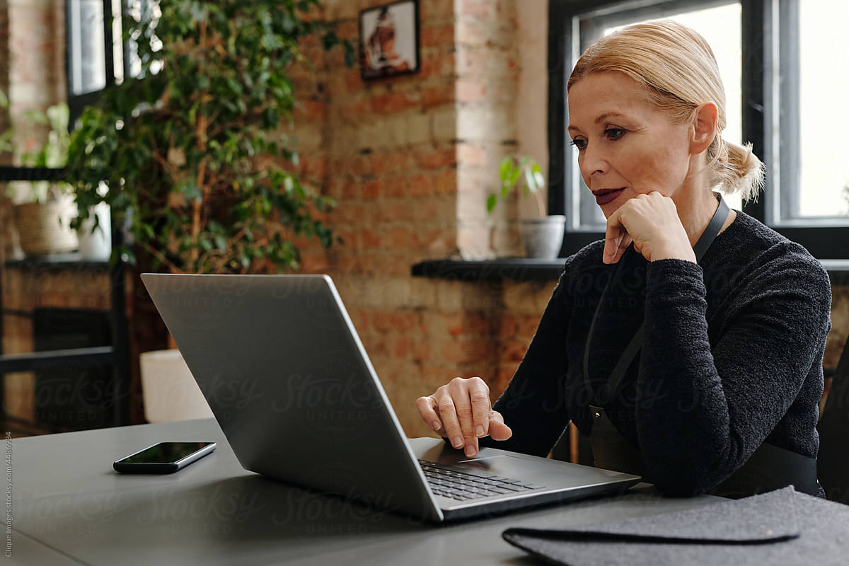 Senior Woman Using Internet on Laptop In Office