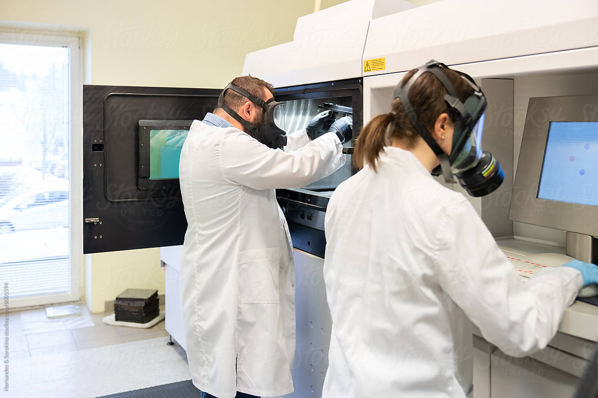 People Using 3D Printer in Laboratory Room