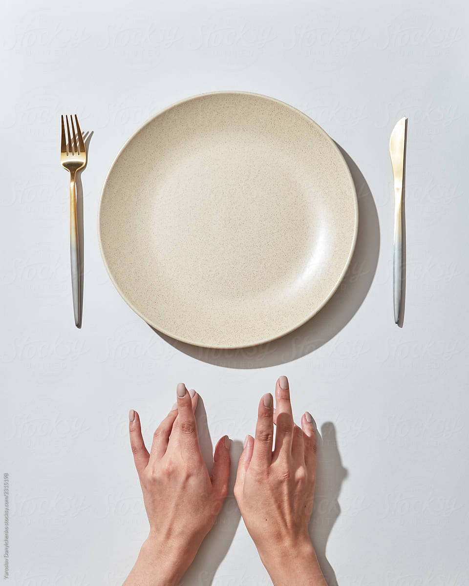 Waiting for dinner at the table, empty plate and hands