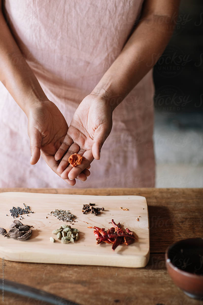 Anonymous Indian Woman Preparing Spices For Homemade Indian Curry