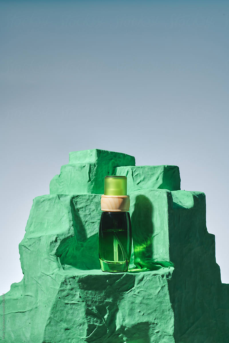 Skincare cosmetic jar on green concrete podium