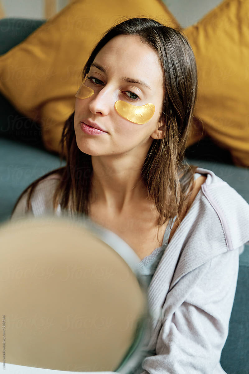 Woman with collagen under eye patch.
