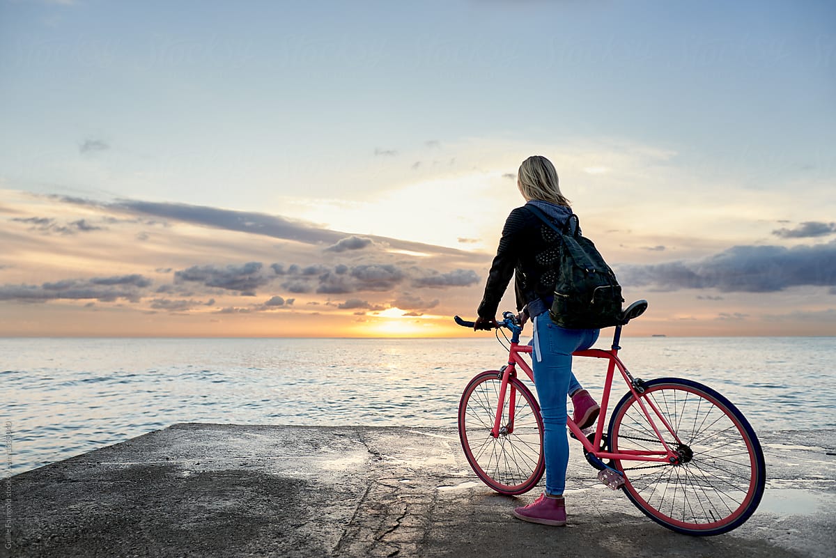 Girl on bike on pier.