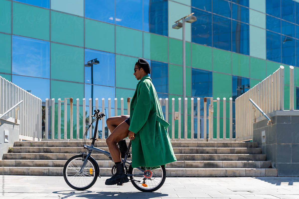 Fancy black man by bike at city