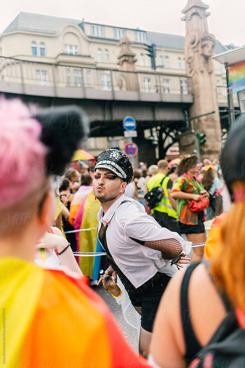 Man in shiny police hat posing for photos at a Pride