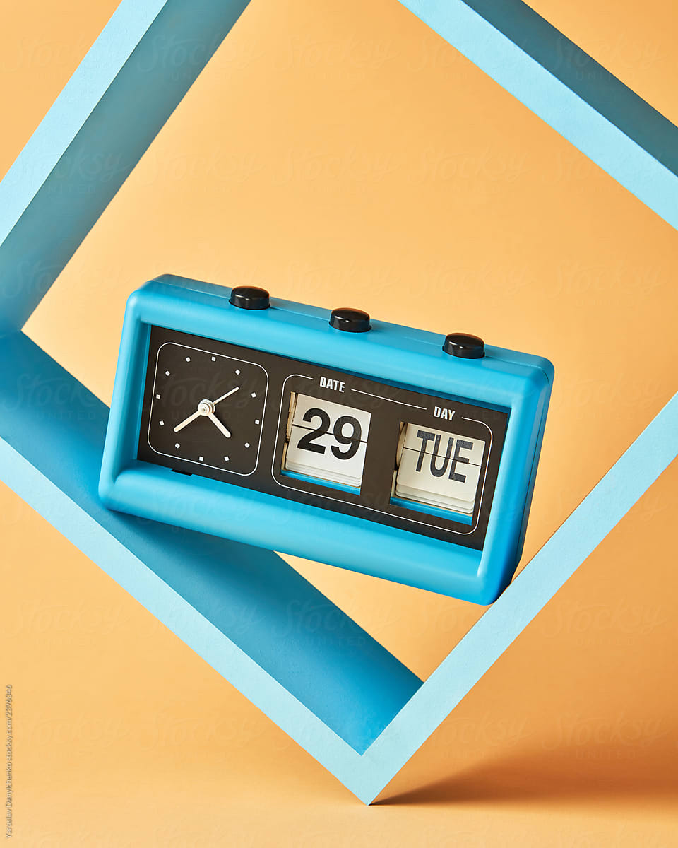Blue retro flip clock with analog timer on square shelf