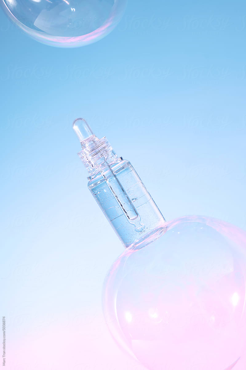 Realistic gel bottle over bubbles on light blue background.