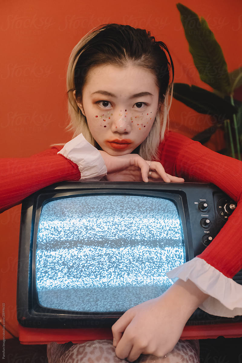 portrait of fashion Asian young woman with a television