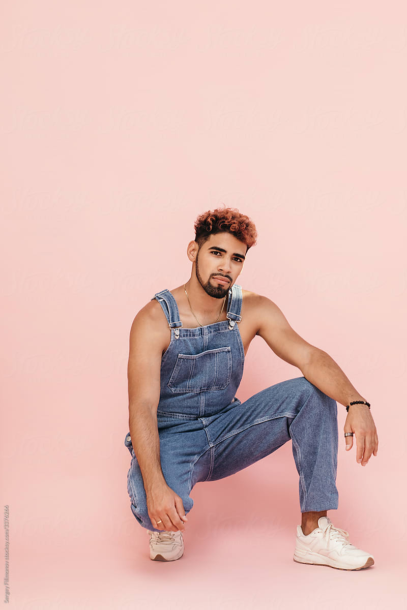 Stylish young ethnic man in denim jumpsuit