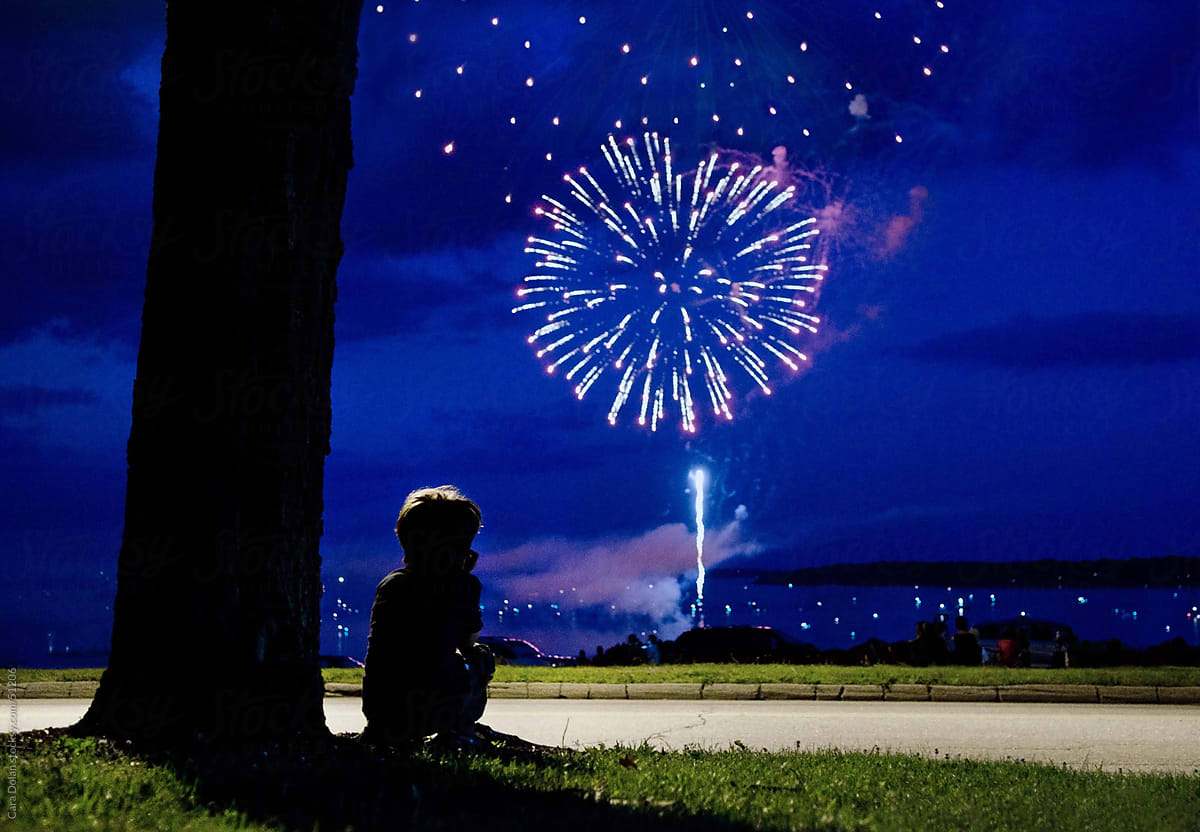 Boy Watching Fireworks in the sky on the 4th of July