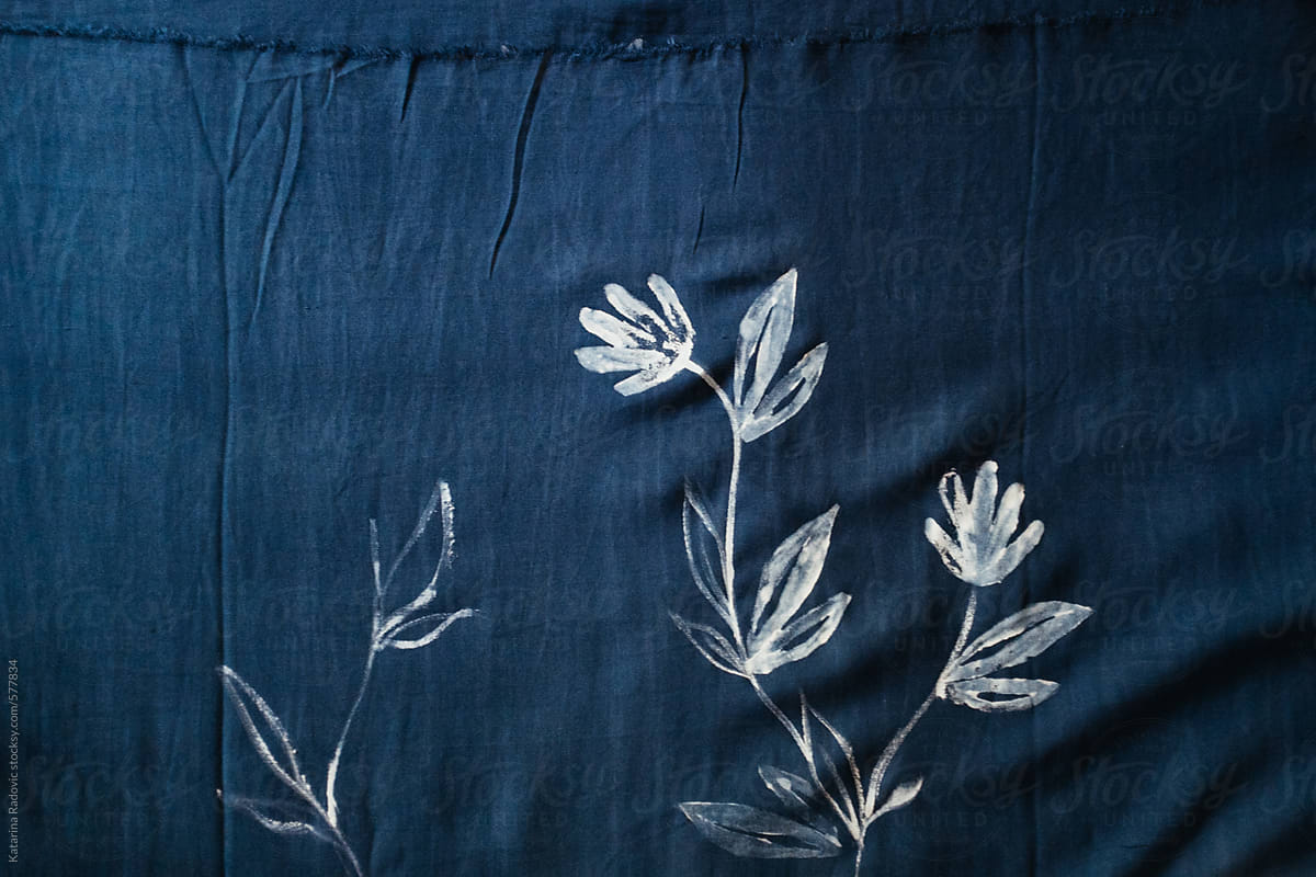 White Flowers Painted on a Blue Fabric