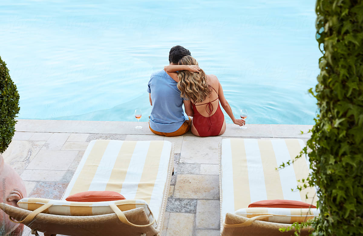 Couple Relaxing On The Edge Of Pool At Resort By Stocksy Contributor Trinette Reed Stocksy 3990