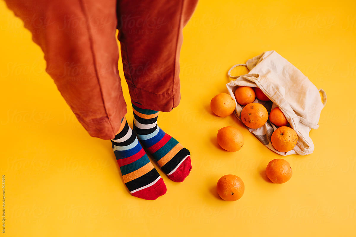 Close-up of feet and oranges